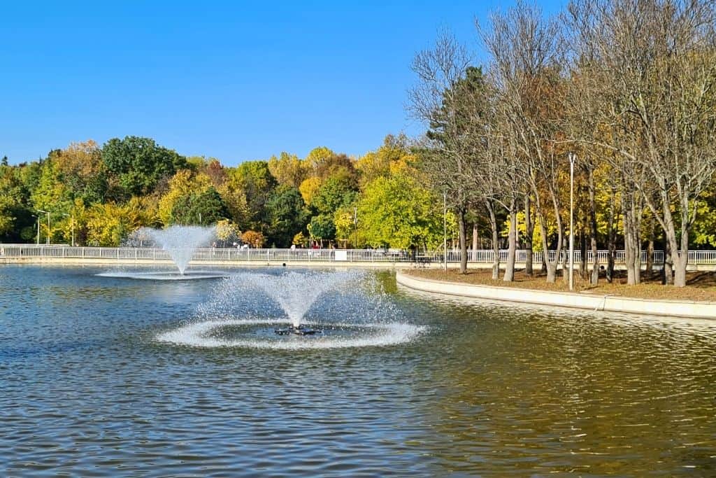 Peaceful lake with fountains surrounded by autumn-colored trees in one of Sofia’s city parks — ideal for travelers seeking relaxing green spaces during their visit.